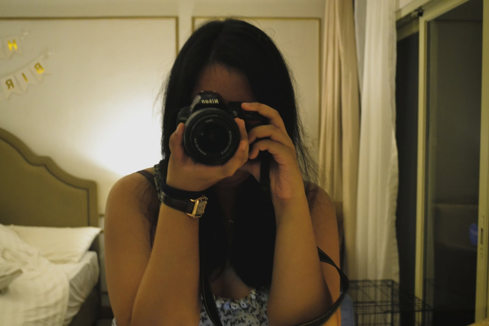 Isabelle taking a photograph with a Nikon camera